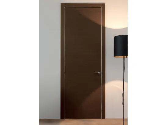 Porta a battente in legno Wengè e stipite con coprifili alluminio Trait di Albed
